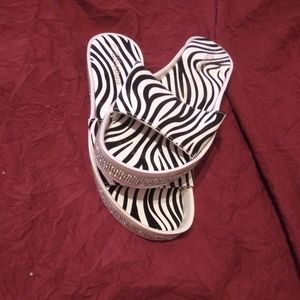 A pair of zebra material slides with rhinestones